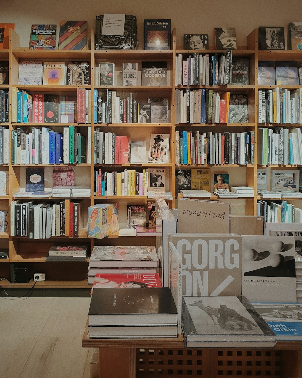 a bookshelf filled with lots of books in a room