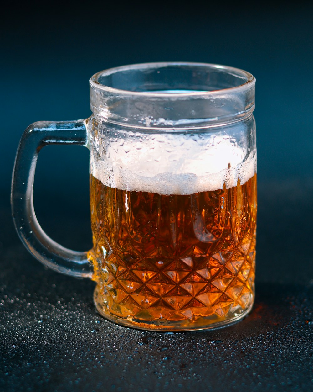 a glass mug of beer on a table