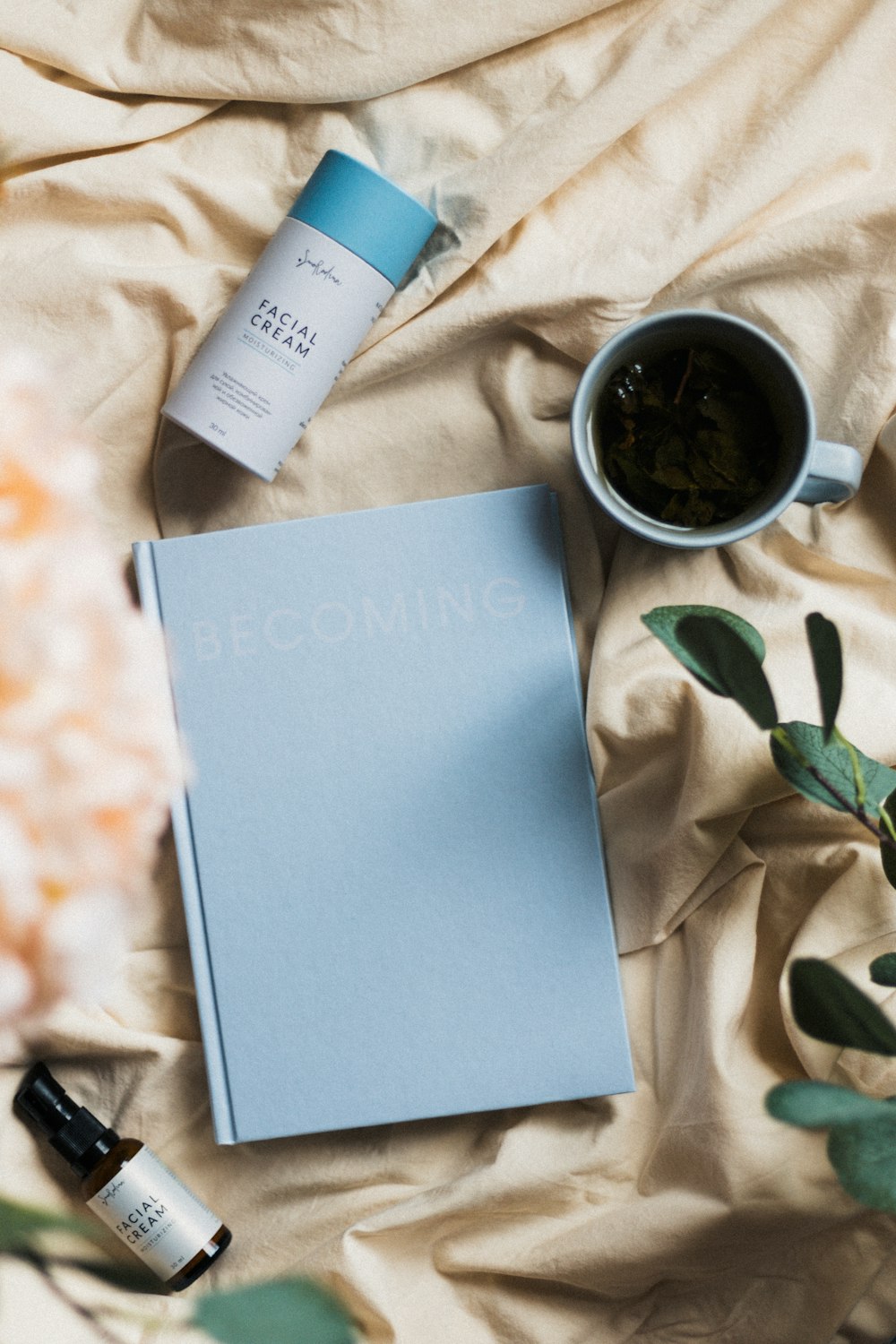 a cup of tea and a book on a bed