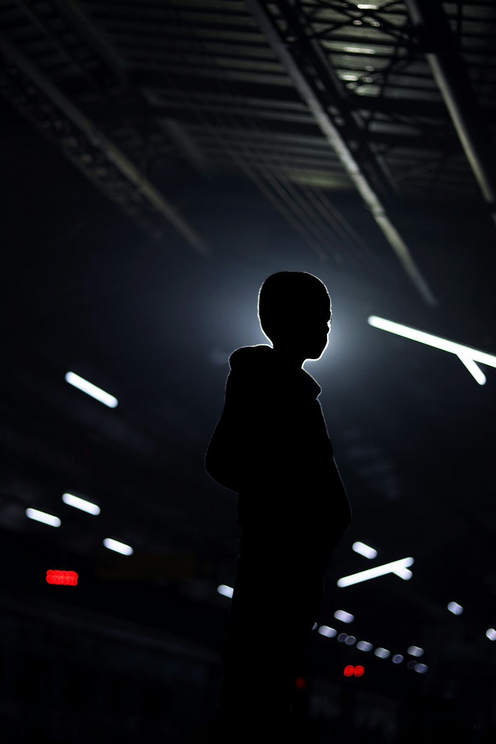 a silhouette of a person standing in a dark room