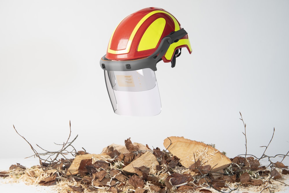 a helmet that is on top of a pile of leaves