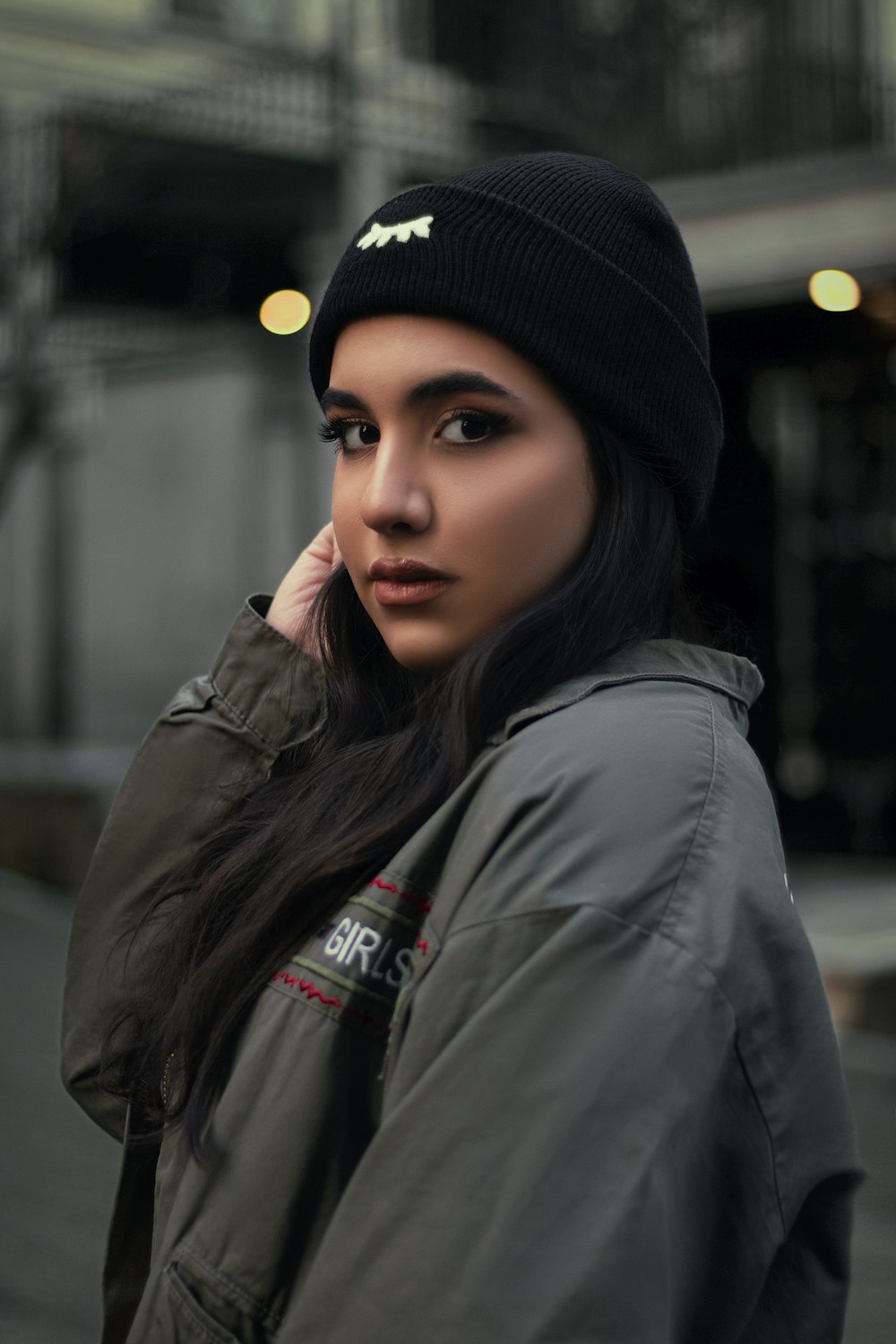 a woman wearing a black hat and jacket