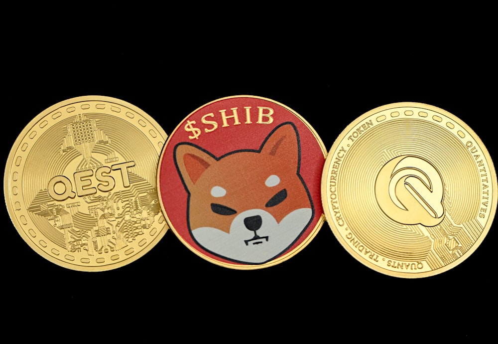 three gold coins with a red and white dog on them