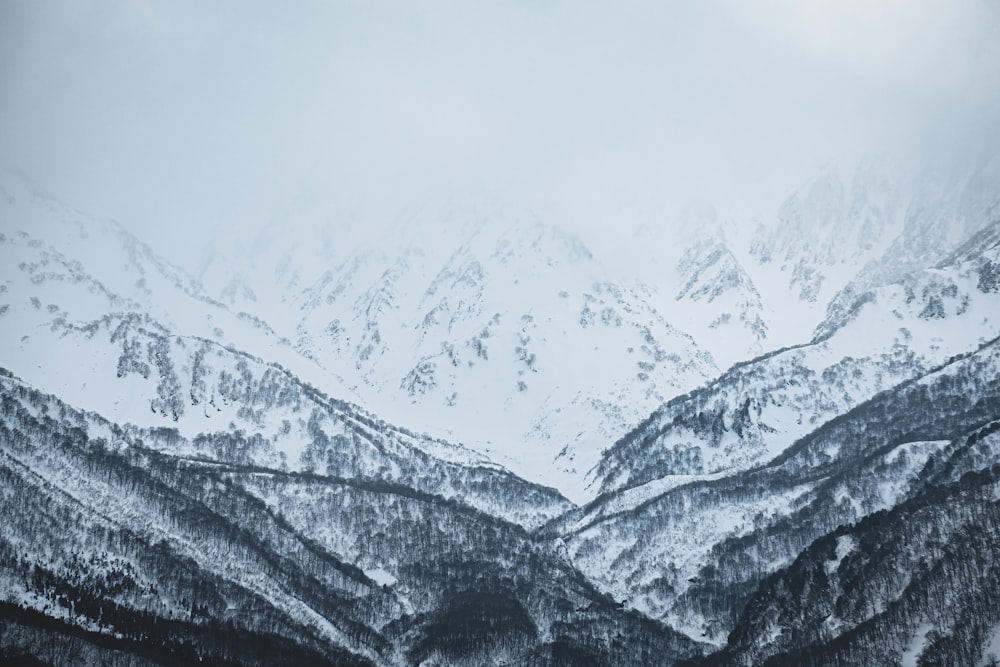 a mountain range covered in snow in the winter