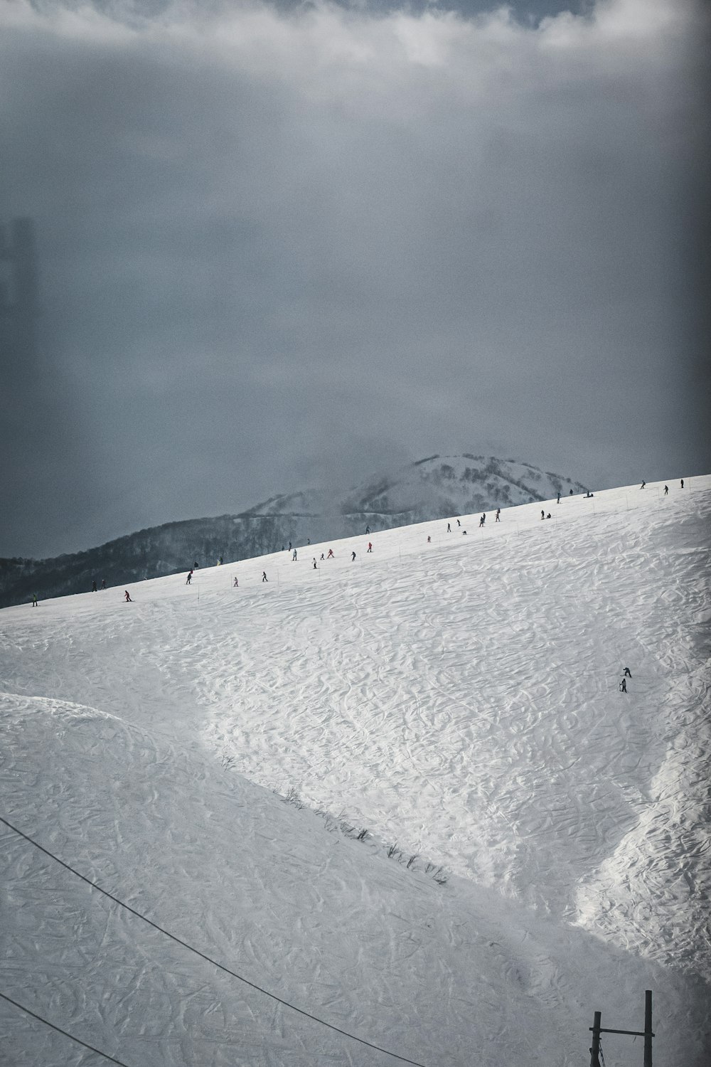 a group of people riding skis down a snow covered slope