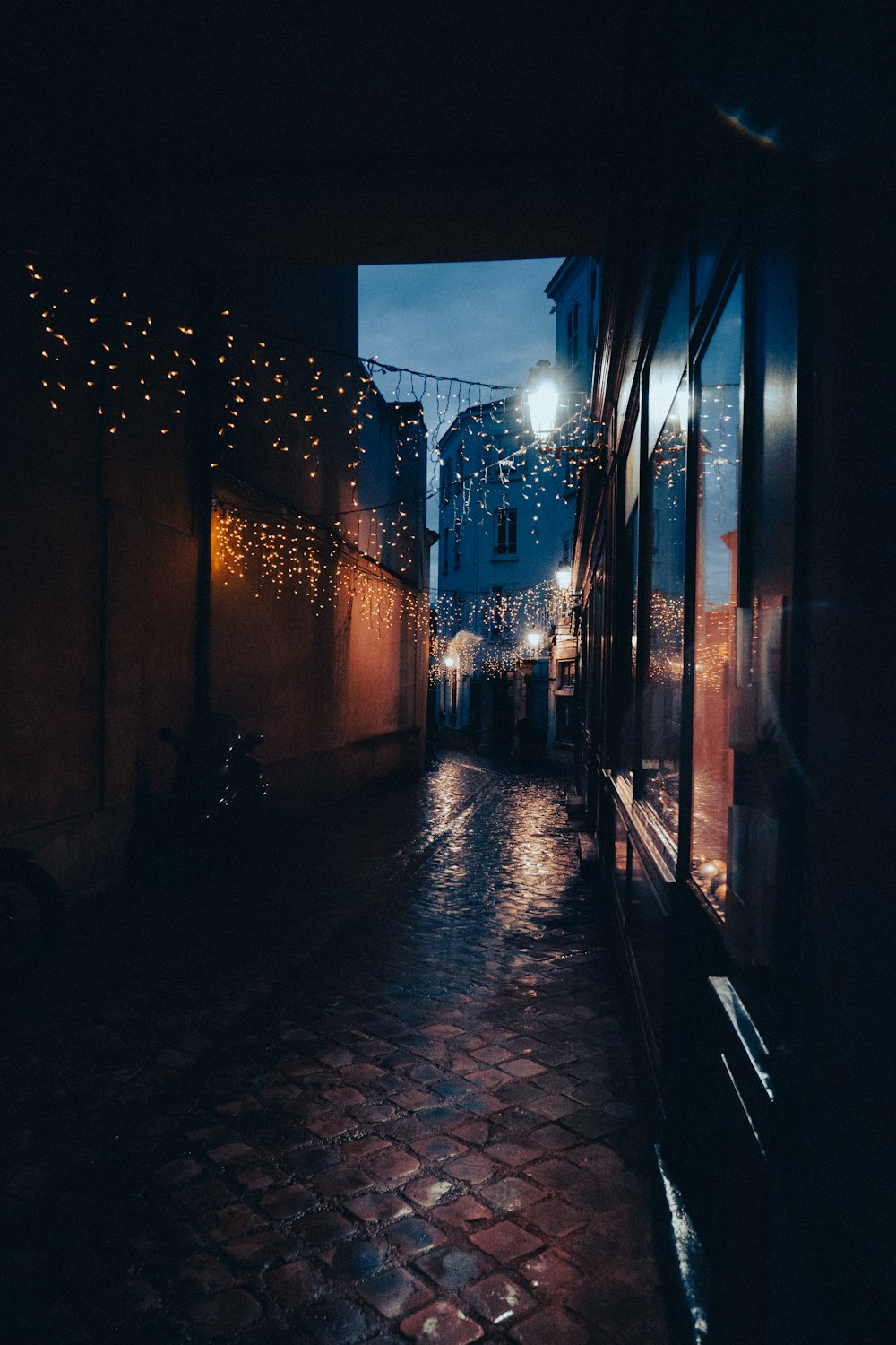 a dark alley with lights on the buildings