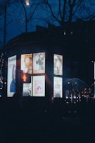Nighttime shot of a popular distribution point with event posters illuminated under soft lights.