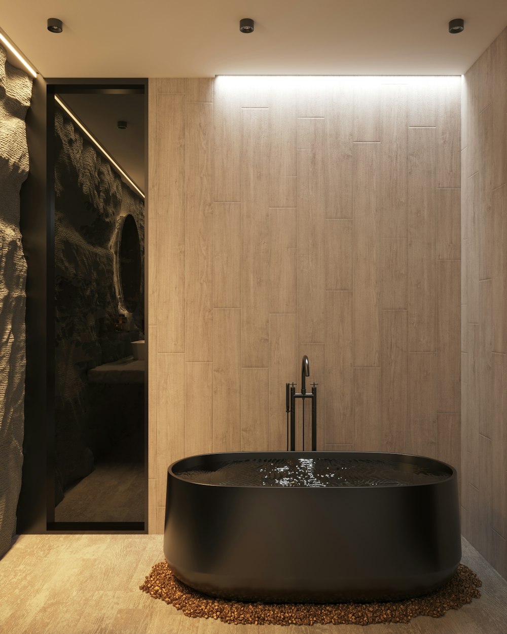 a large black bath tub sitting next to a stone wall