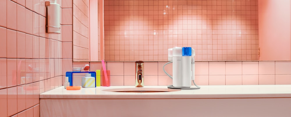 a bathroom with pink tiles and a white sink