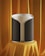 A modern, cylindrical speaker with a sleek design is displayed on a pedestal draped in luxurious orange fabric. The speaker has a gray and black fabric exterior with a subtle texture and a white top edge.