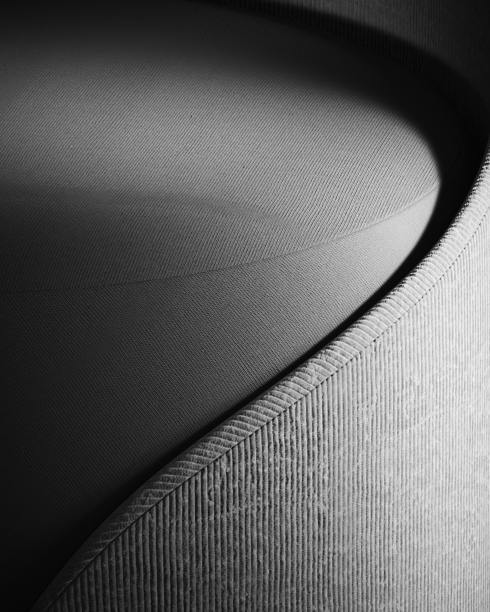 a black and white photo of a curved lamp shade