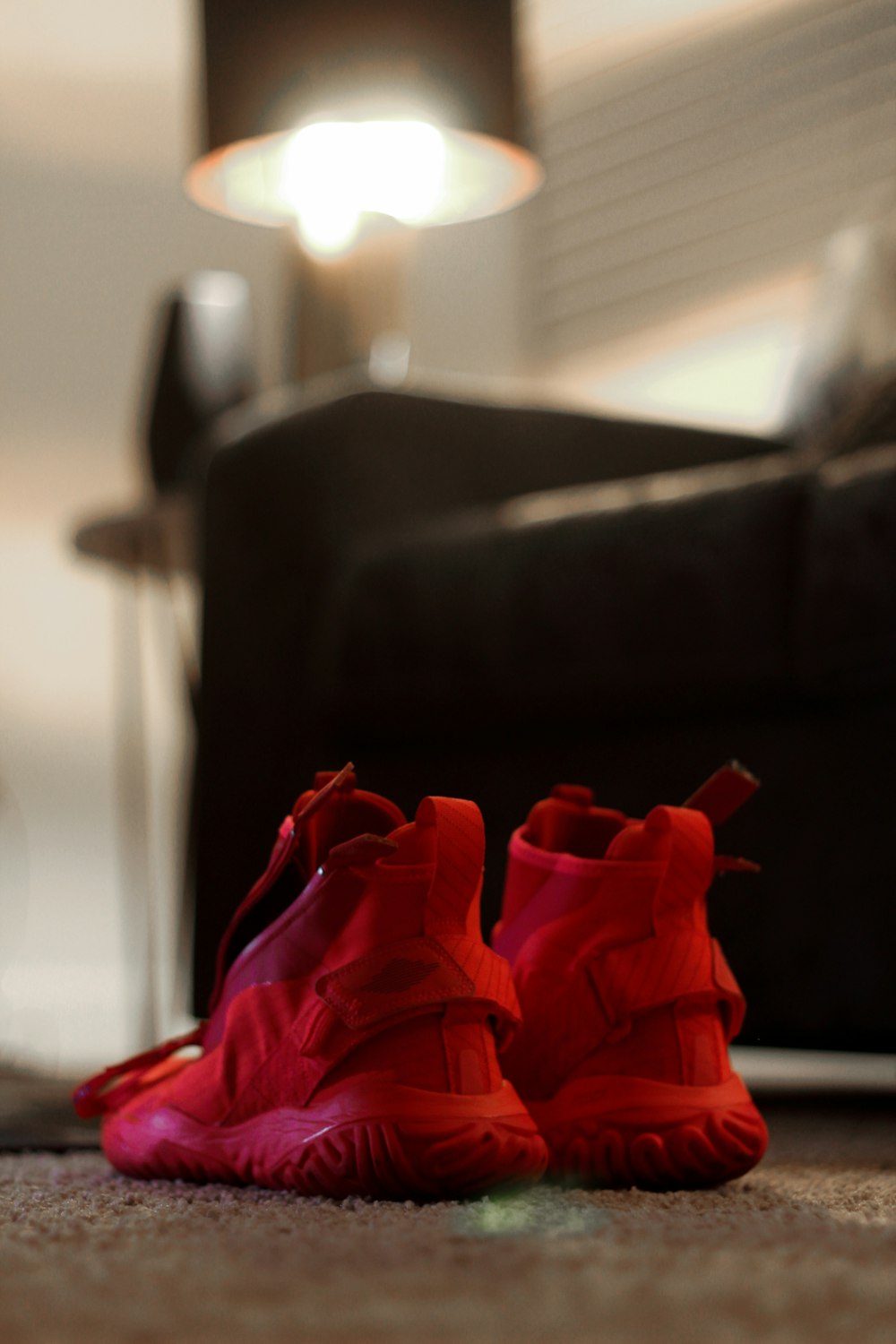 a pair of red shoes sitting on the floor