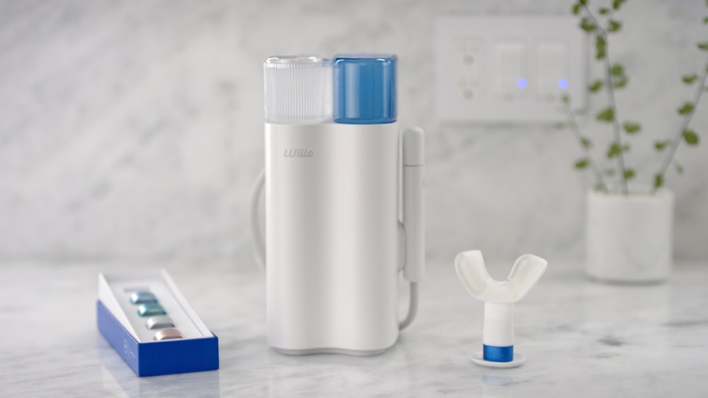 a couple of toothbrushes sitting on top of a counter