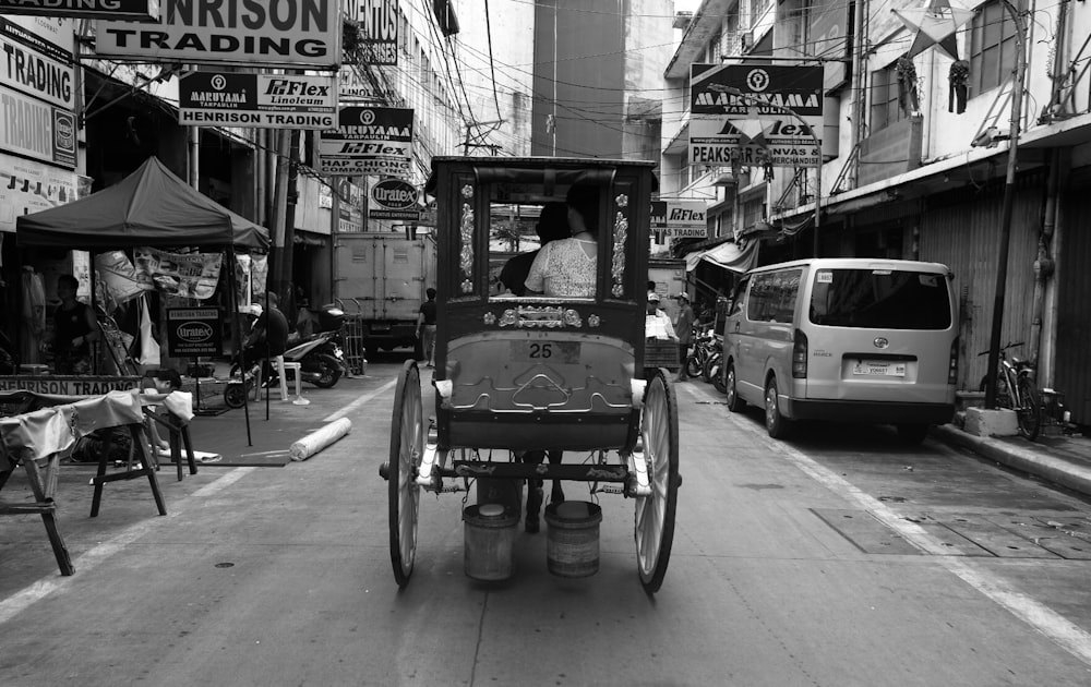 a horse drawn carriage driving down a street