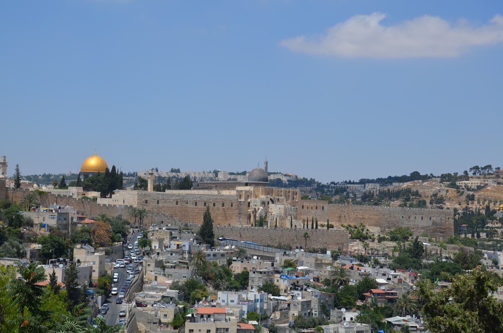 the old city of jerusalem with the dome of the rock in the background