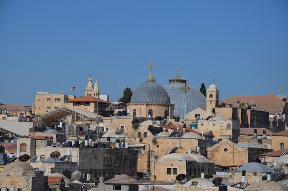 a city with a lot of buildings and a cross on top of it