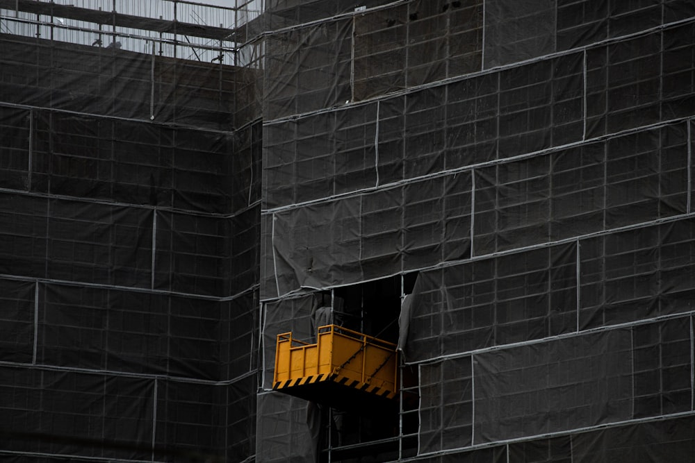 a yellow object is sticking out of the side of a building