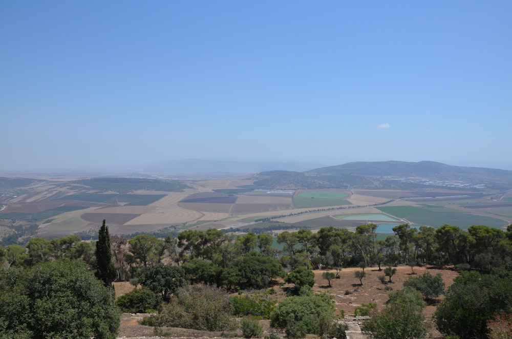 a view of the countryside from the top of a hill