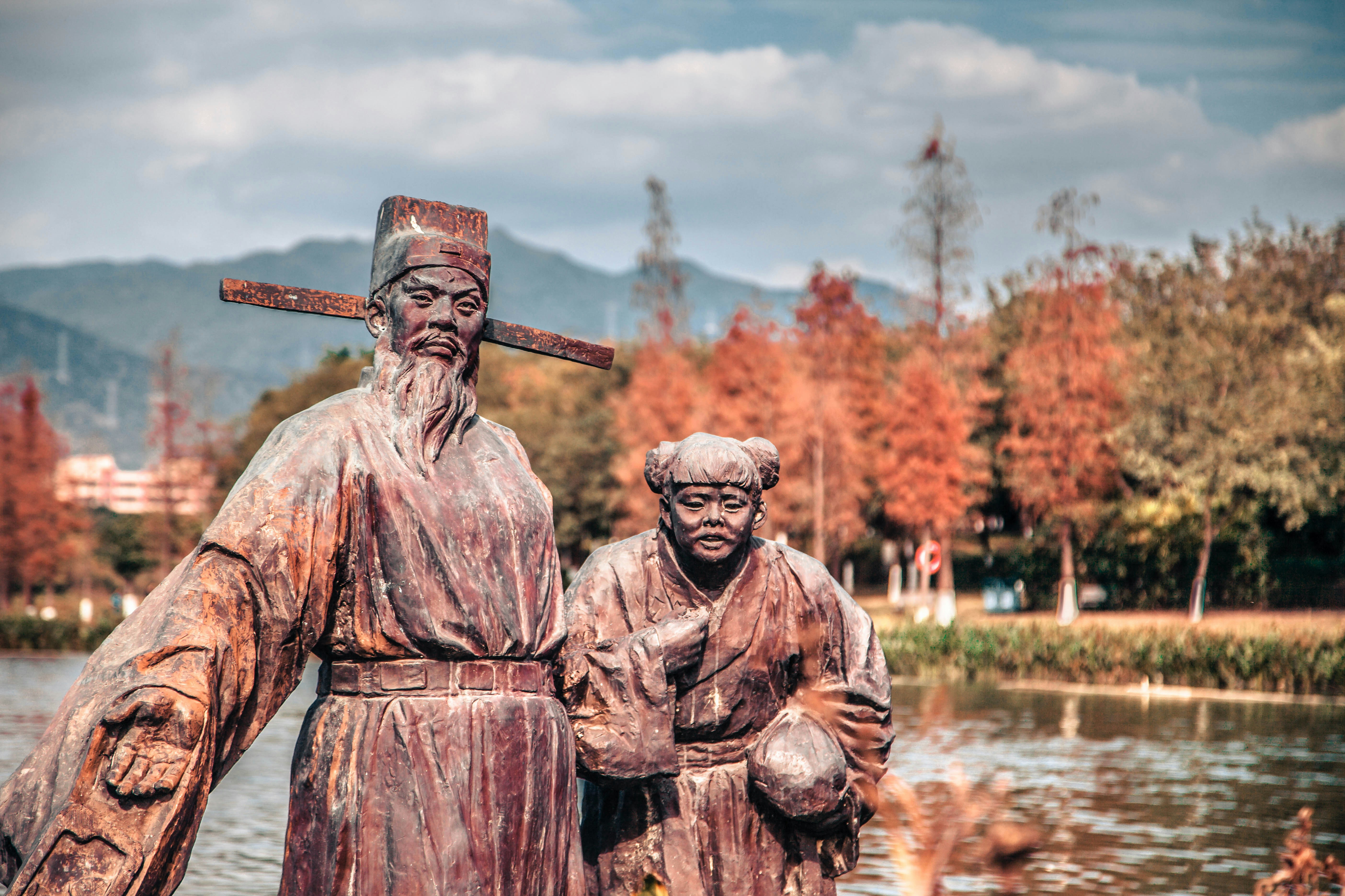 a statue of a man and a woman holding a cross