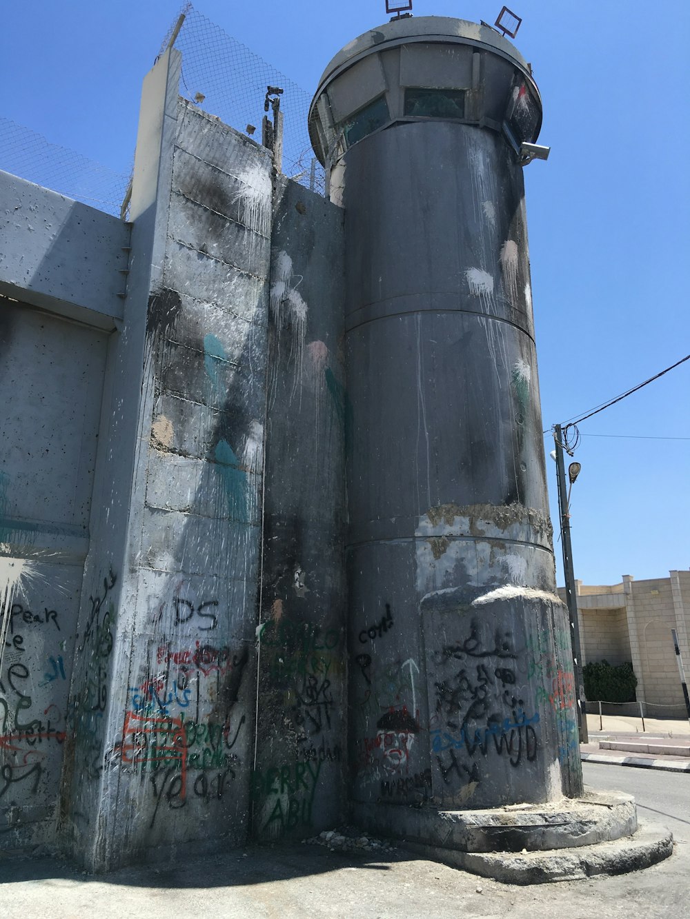a concrete structure with graffiti on the side of it