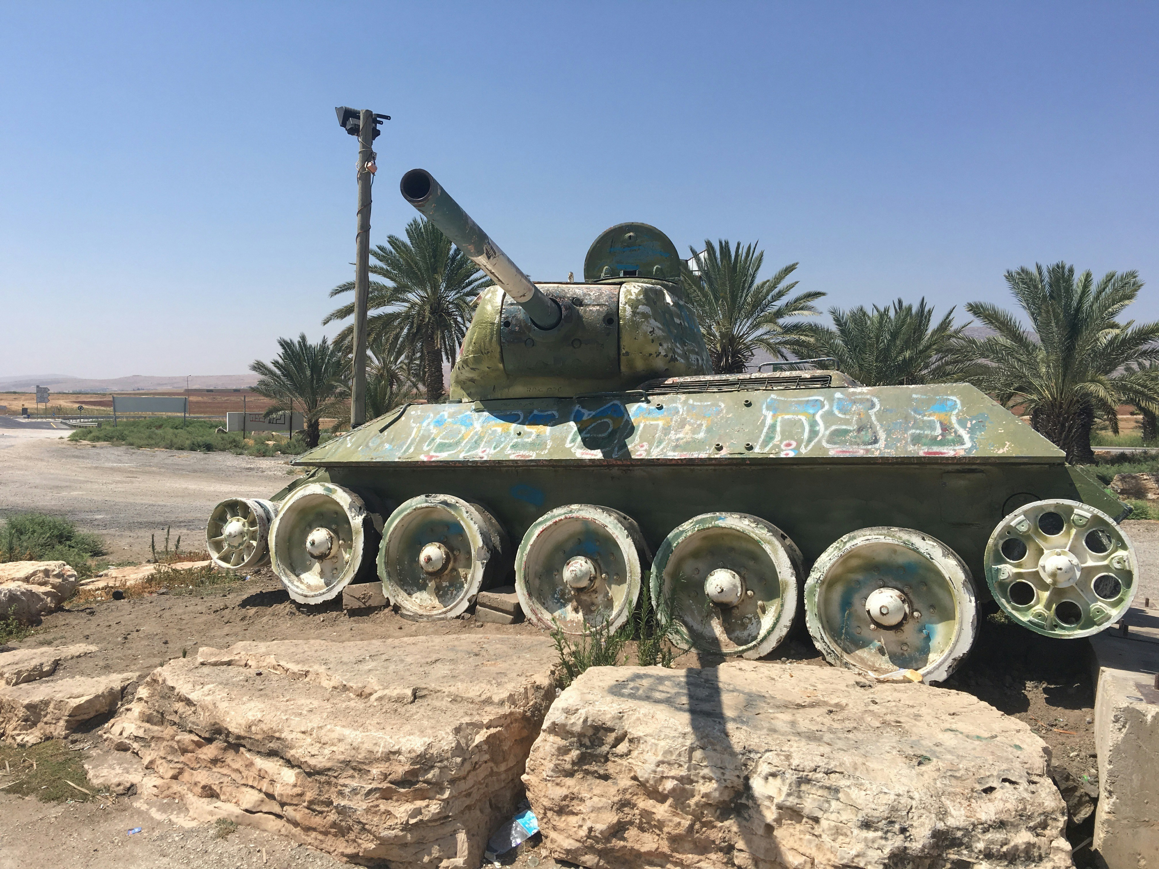 a tank sitting on top of a pile of rocks