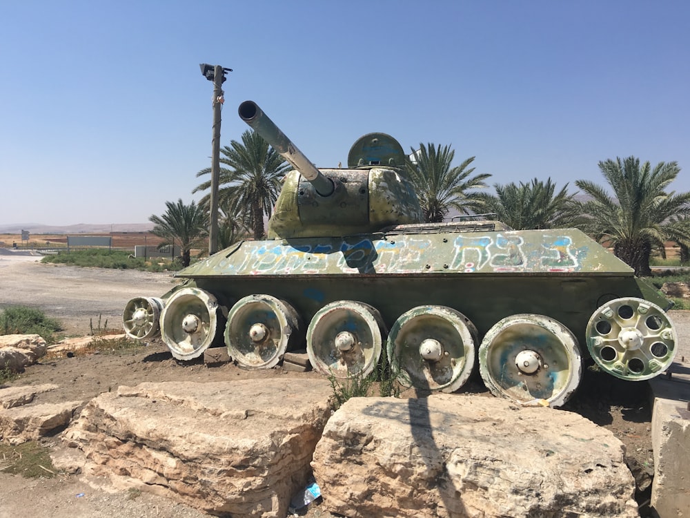 a tank sitting on top of a pile of rocks