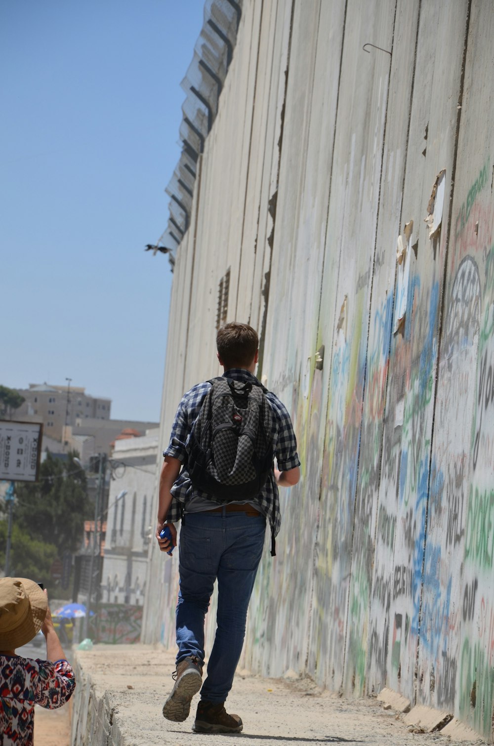 a man with a backpack walking down a street