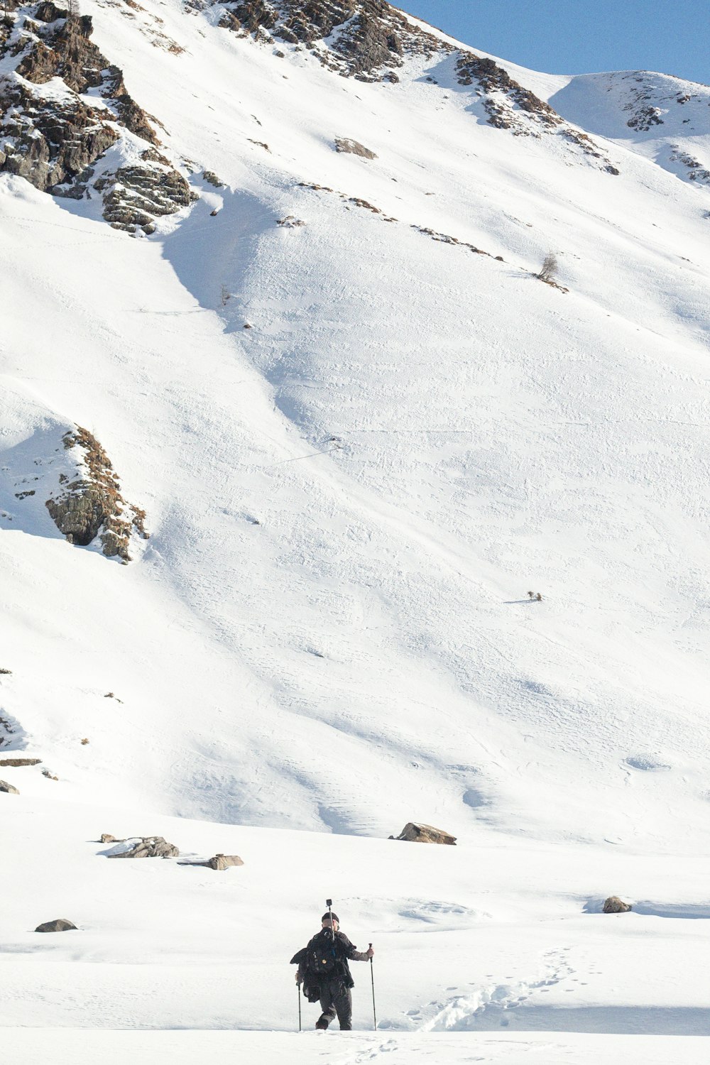 a man riding skis down a snow covered slope