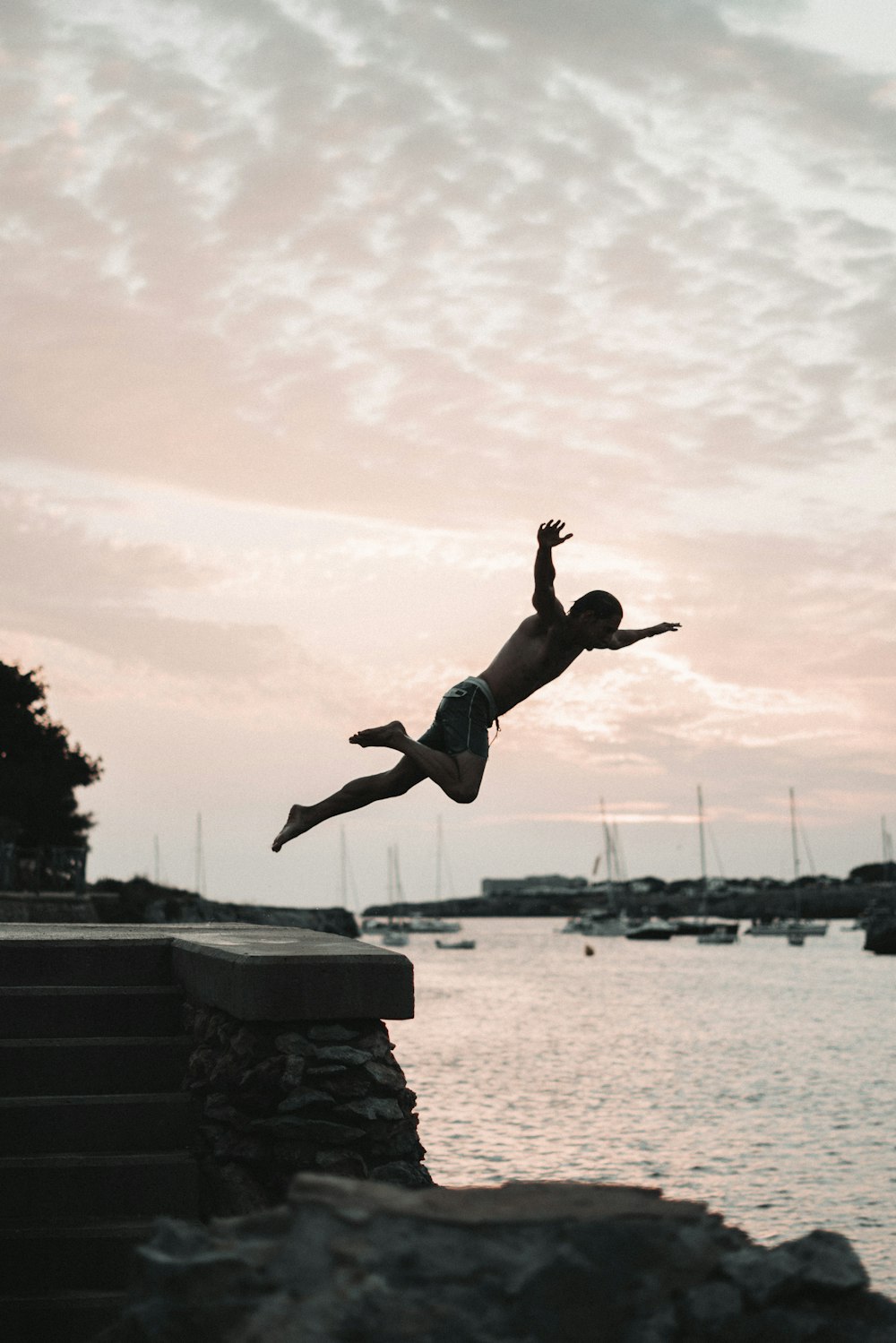 a person jumping into the water from a dock