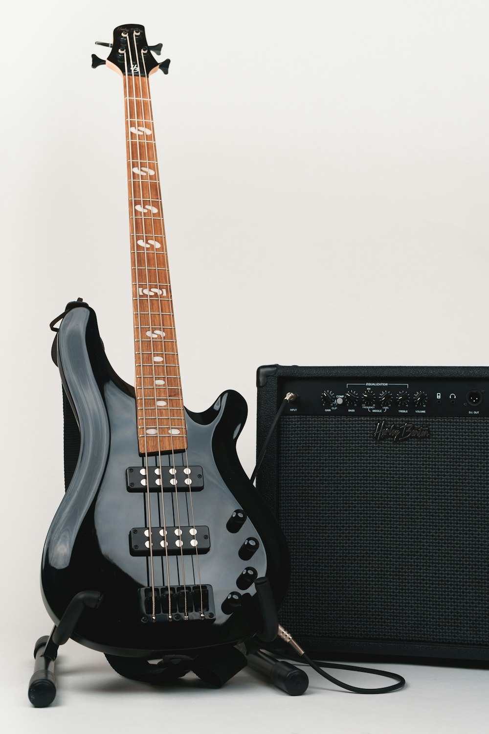 a black guitar and amp sitting next to each other