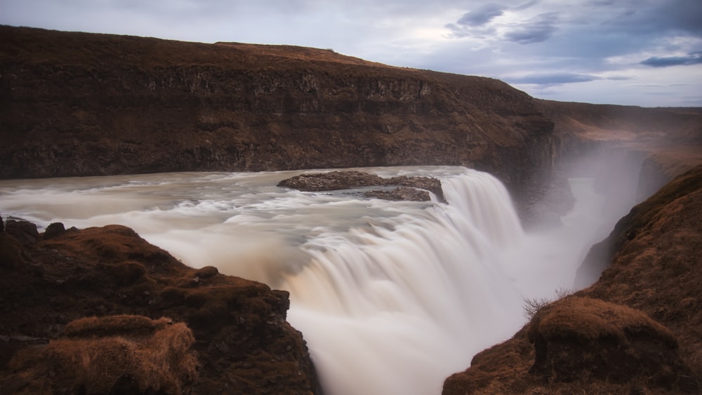 a large waterfall with water coming out of it