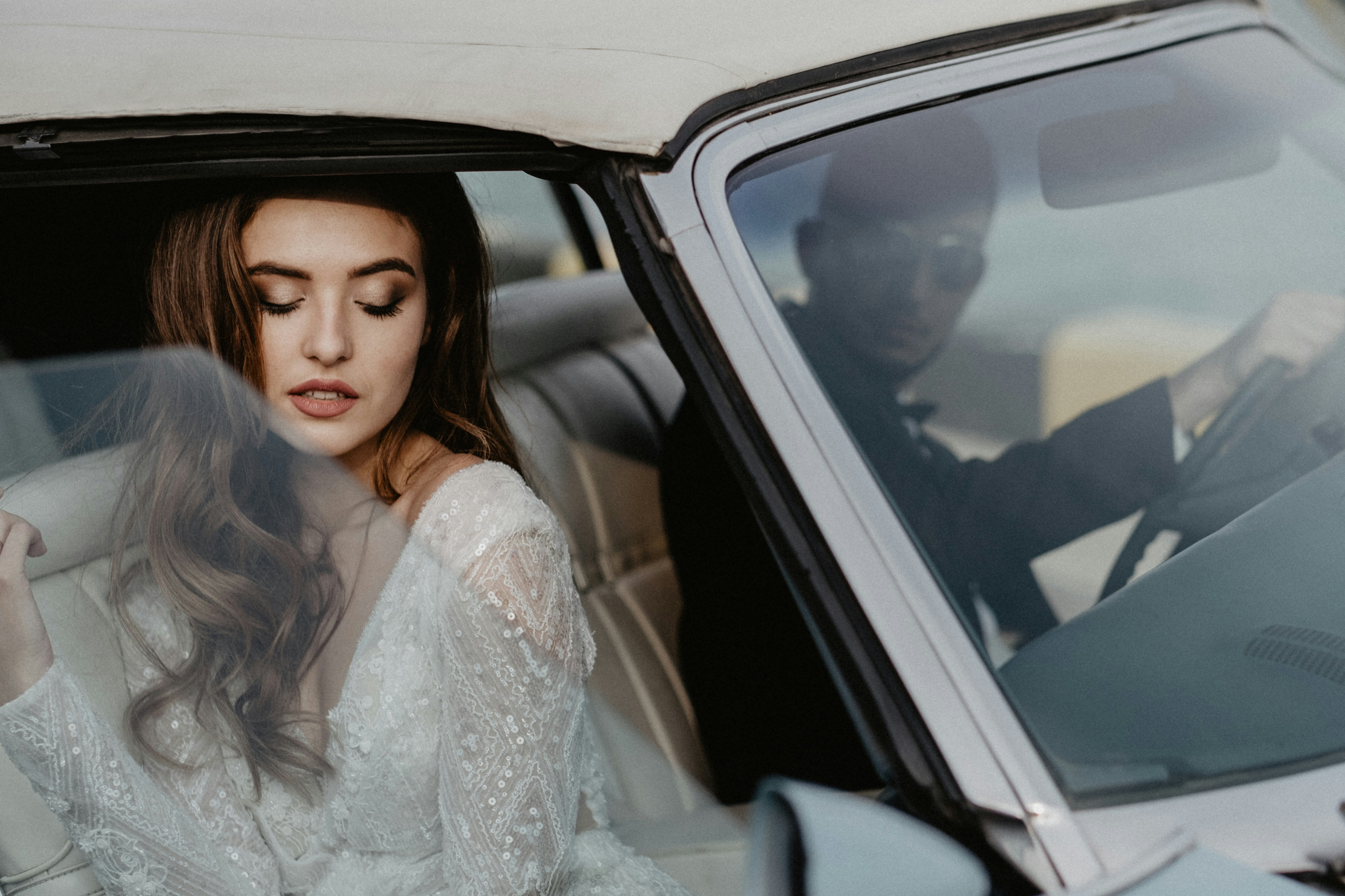 a woman sitting in the passenger seat of a car