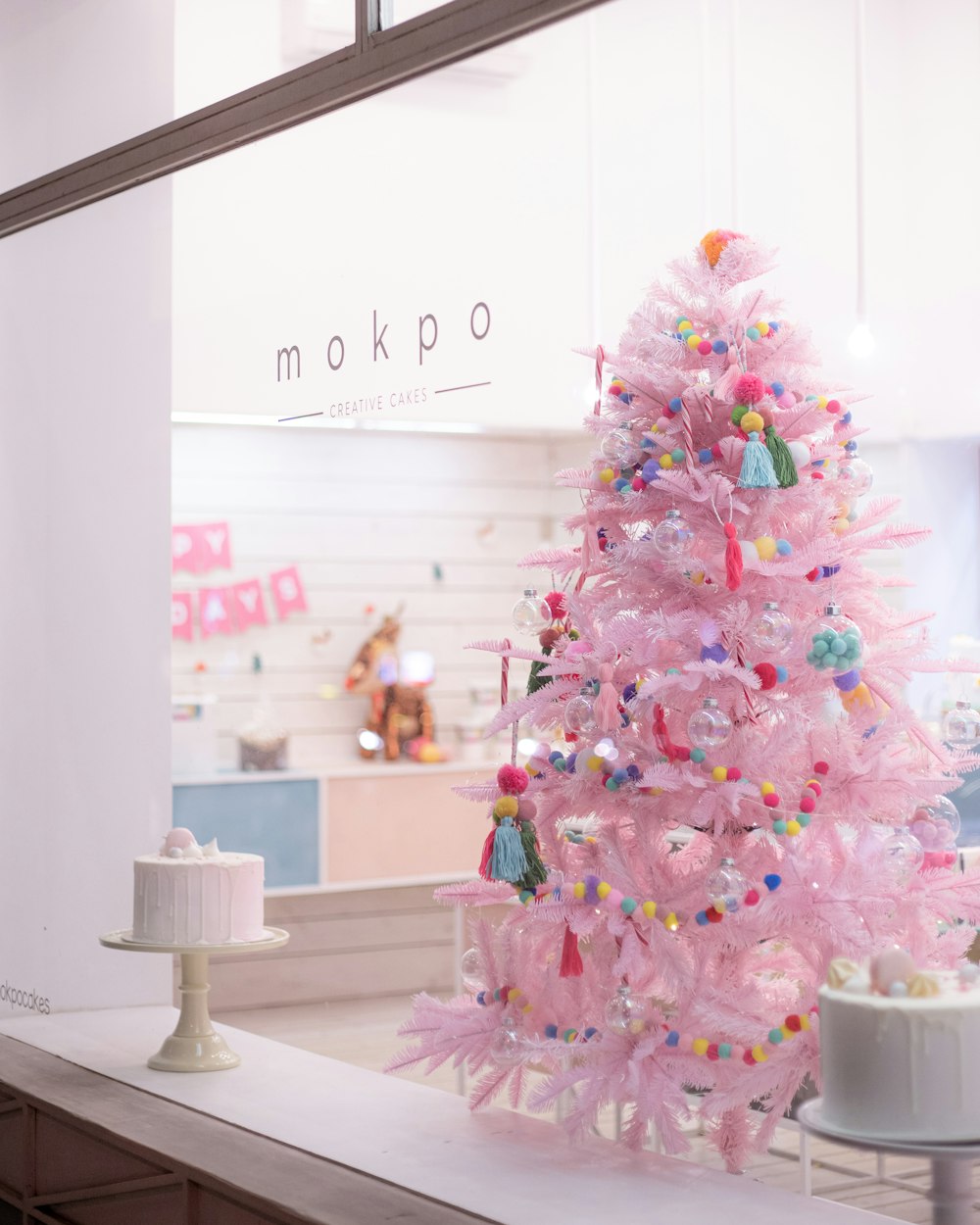 a pink christmas tree sitting on top of a counter