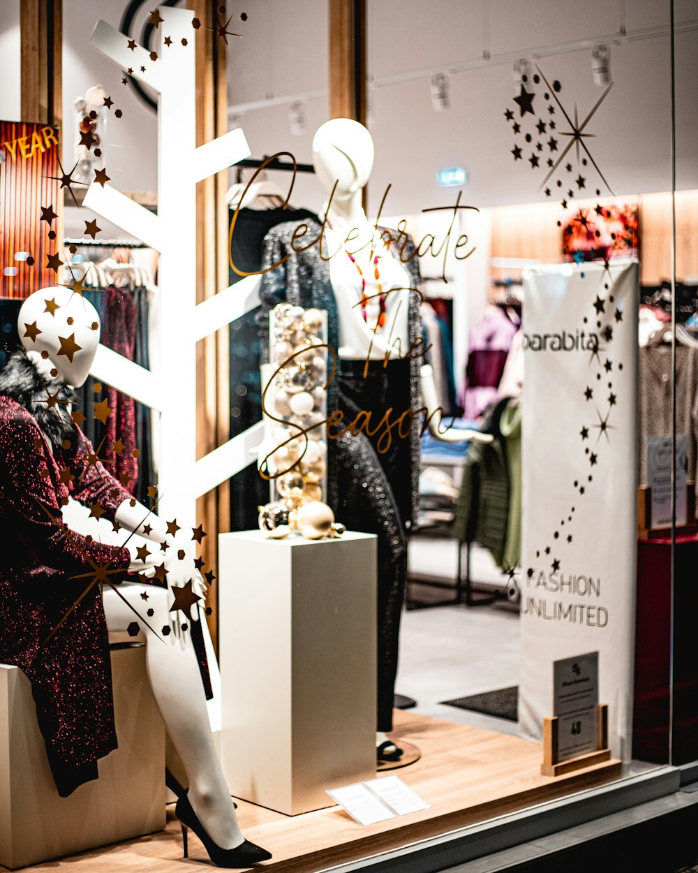 a window display with mannequins dressed in black and white