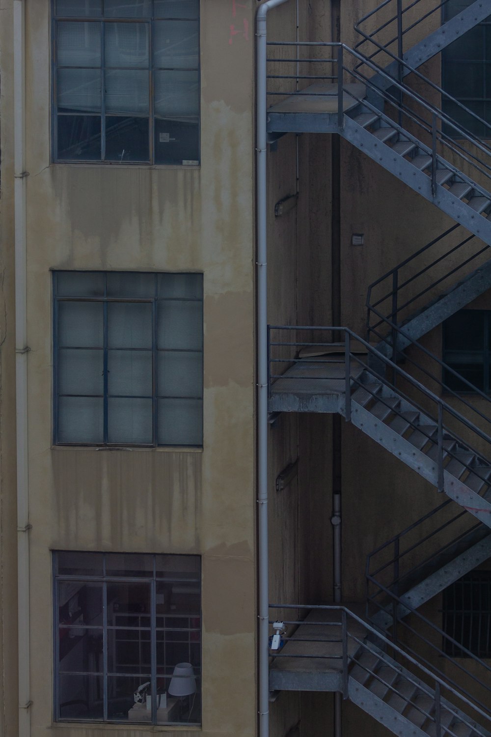 a tall building with a fire escape next to it