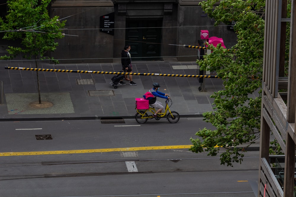 a person riding a small bike on a city street