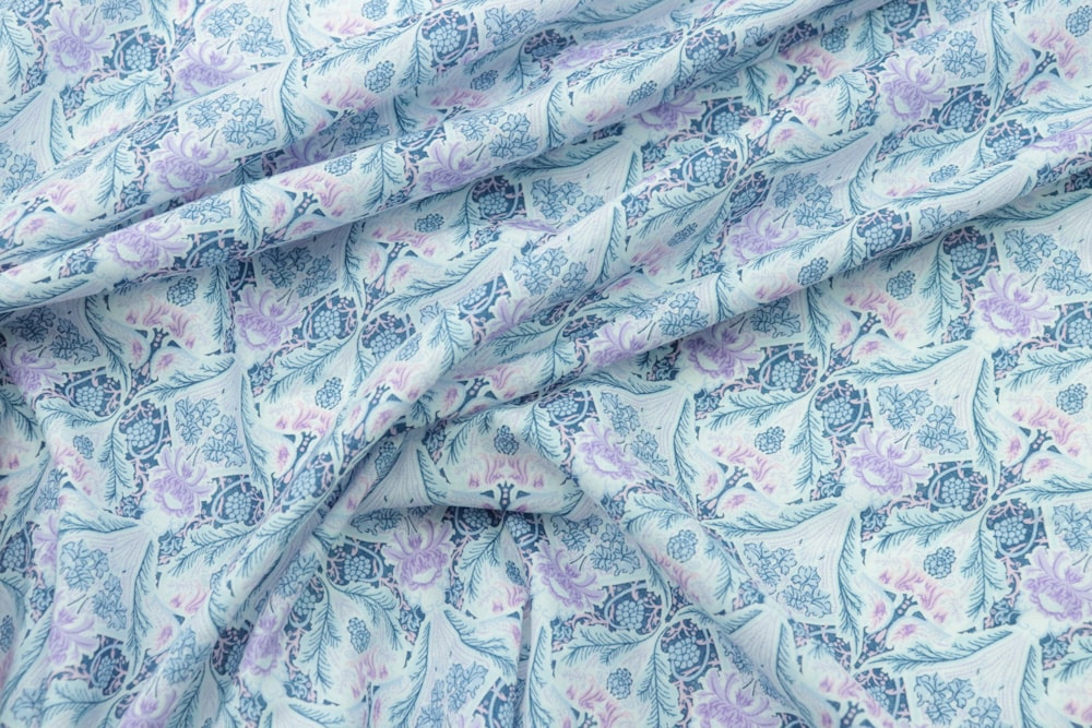 a close up of a blue and purple flowered fabric