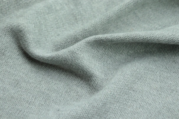 Close-up of the premium fabric texture of a Roze Pulse t-shirt, highlighting its sustainable and breathable quality.