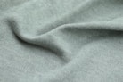a close up view of a light green fabric