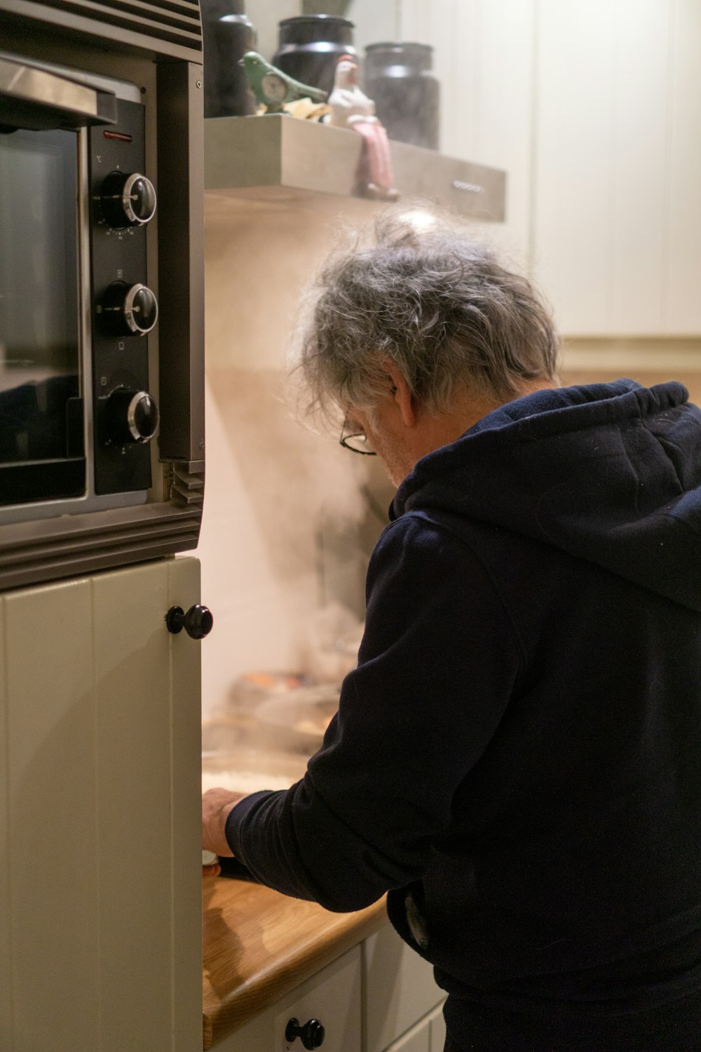 a person standing in front of a microwave oven