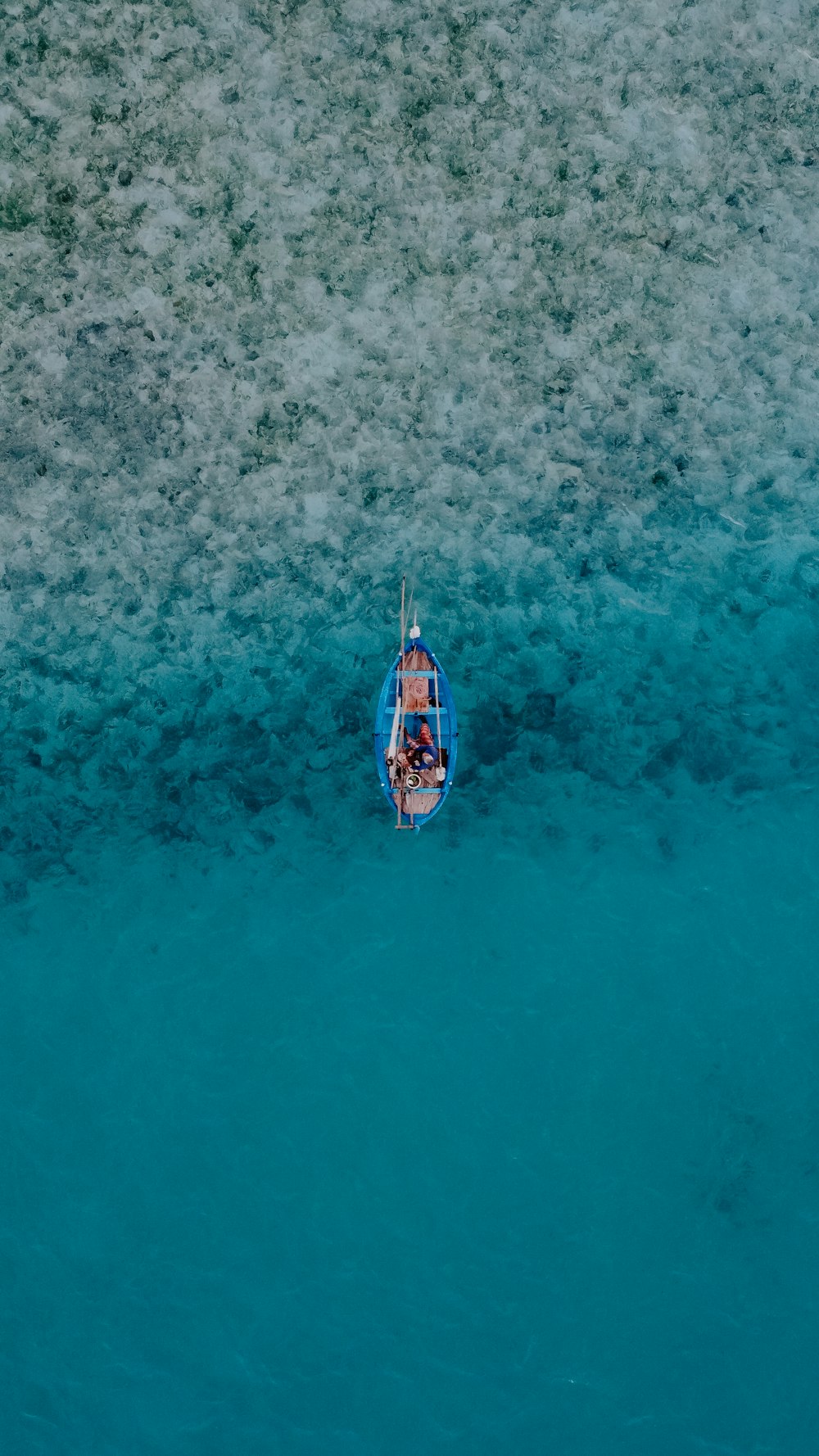 a small boat floating on top of a body of water