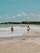 a couple of men standing on top of a sandy beach