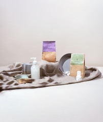 a table topped with a plate and bottles of lotion