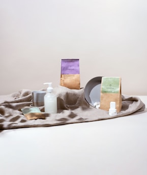 a table topped with a plate and bottles of lotion