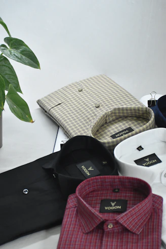 a white table topped with lots of different types of shirts