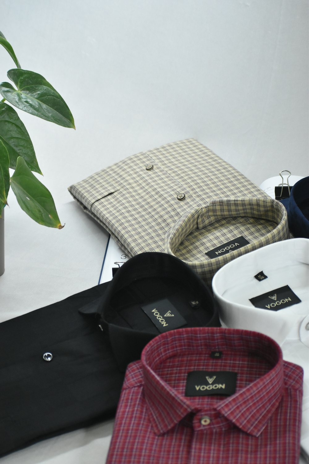 a white table topped with lots of different types of shirts