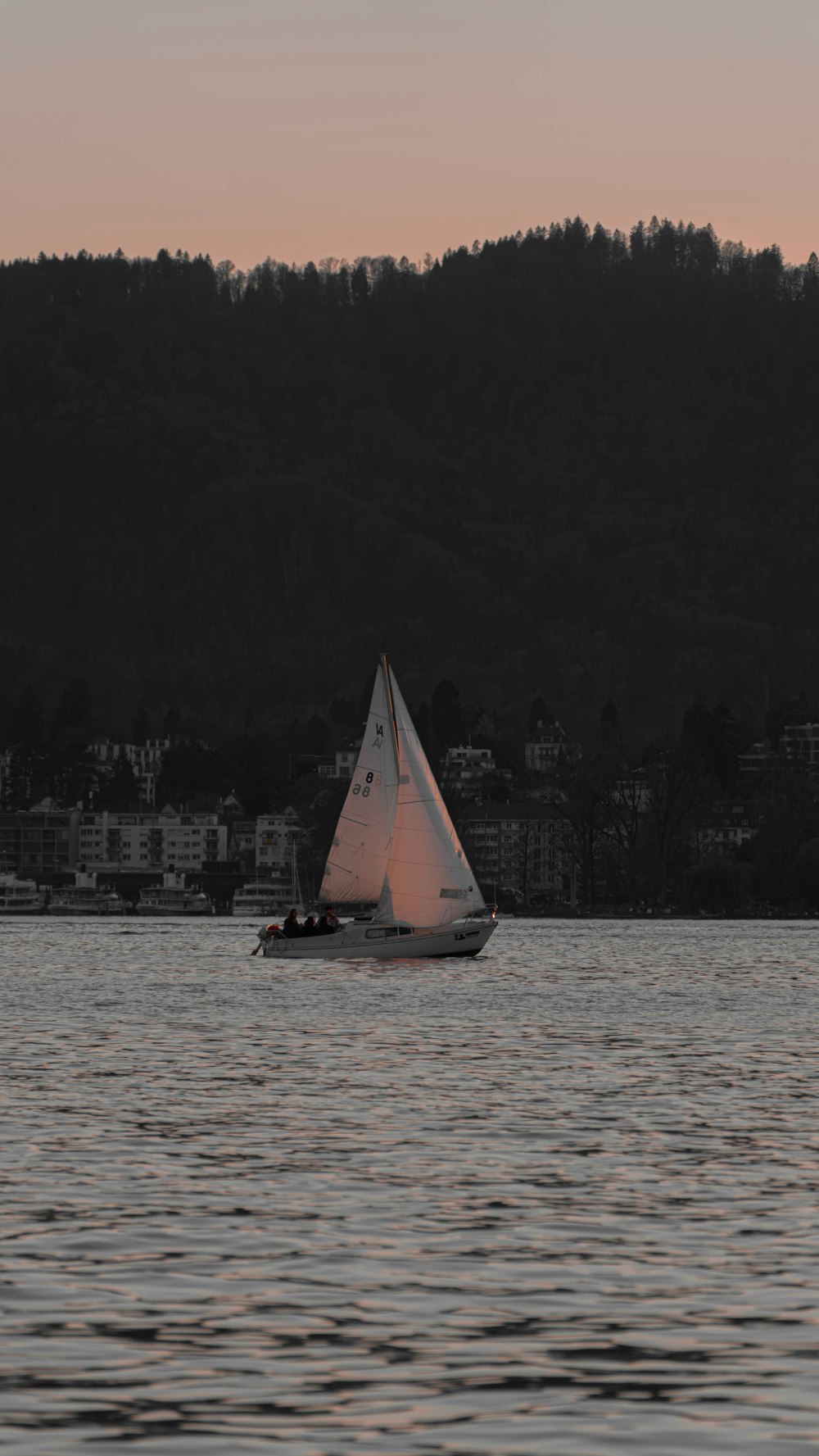 a small sailboat in a large body of water