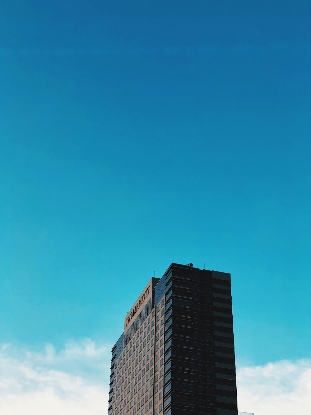 a tall building with a blue sky in the background