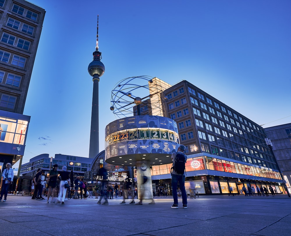 a group of people standing in front of a tall building