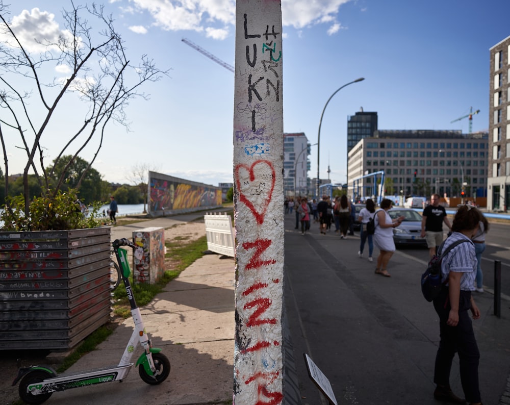 a pole that has some graffiti on it